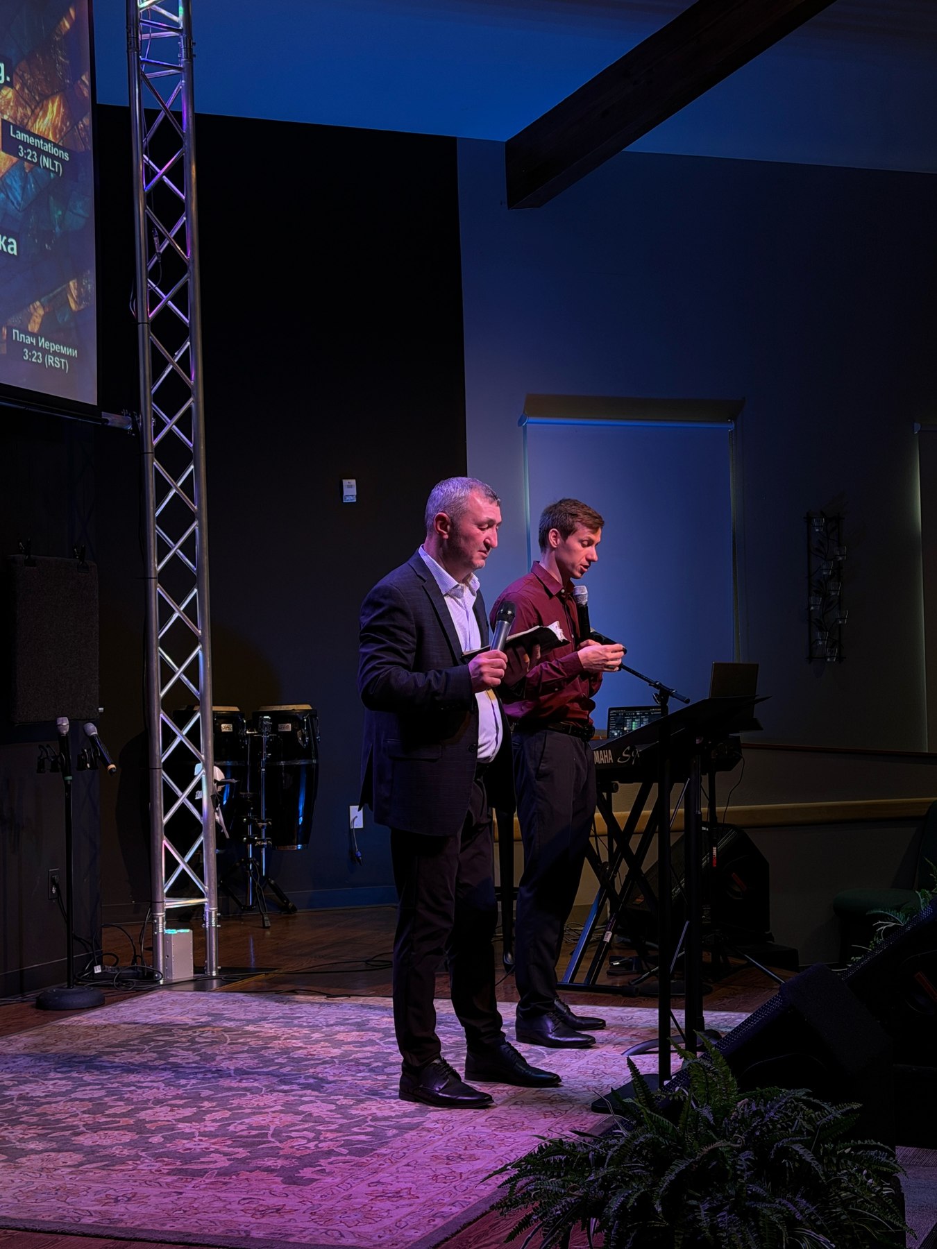 Ministers praying together on stage