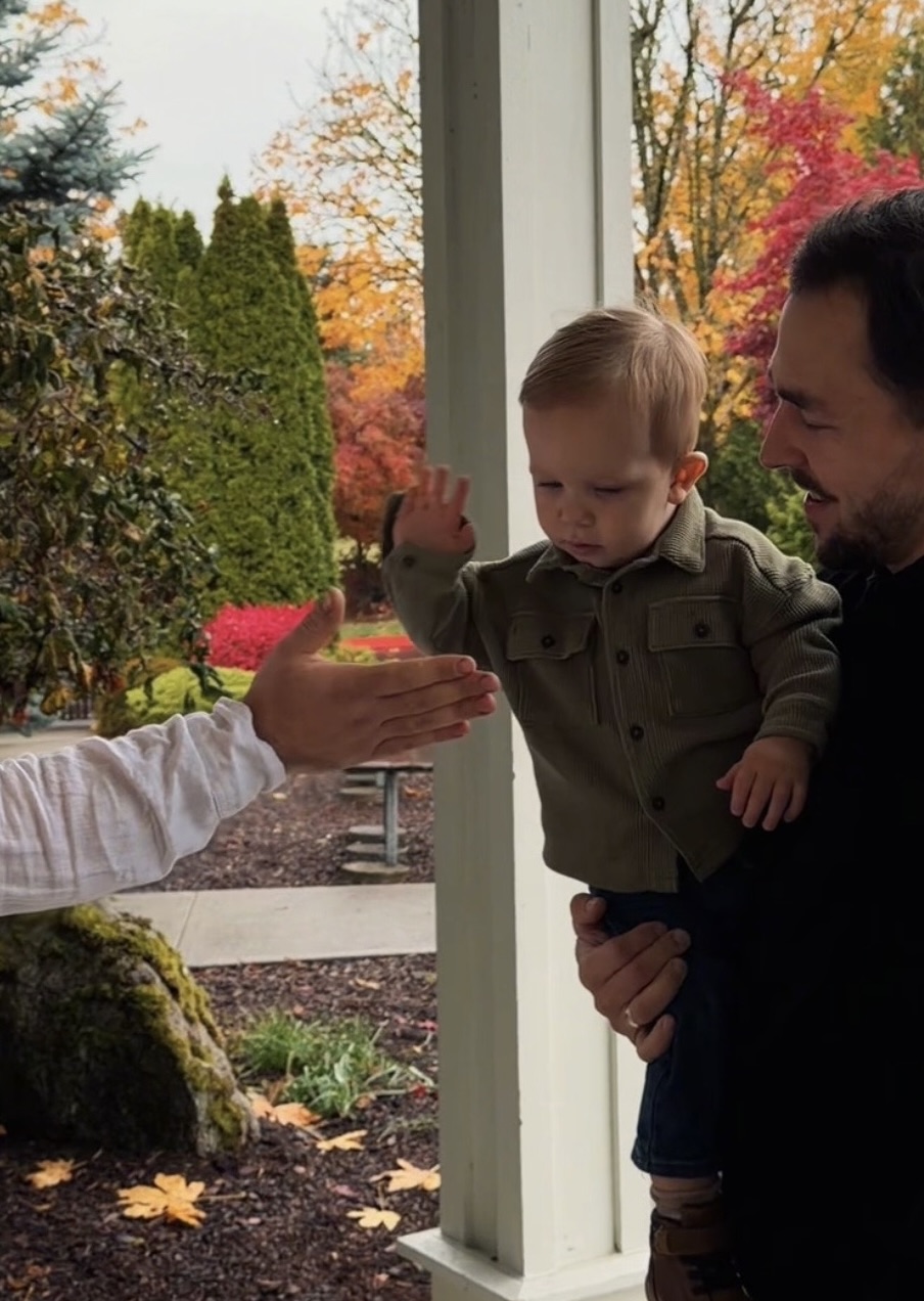 Friendly church greeters welcoming a family